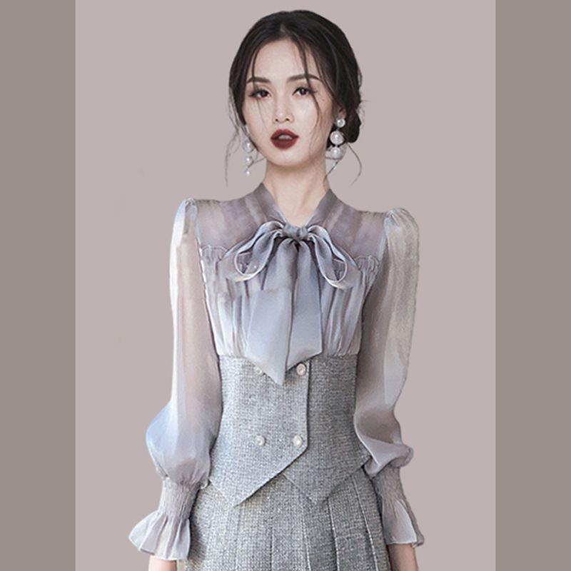 Hong Kong style retro fashion suit female 2023 spring and autumn new foreign style bow top pleated skirt two-piece set