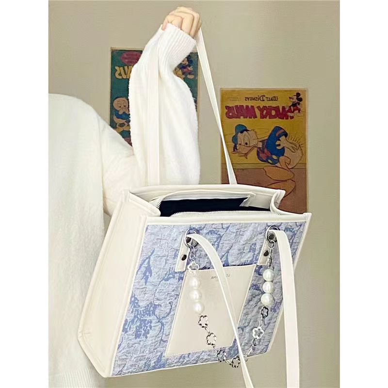 Bag women's 2022 new personality sea salt blue jacquard cloth large capacity commuter tote bag high-end sense niche women's bag
