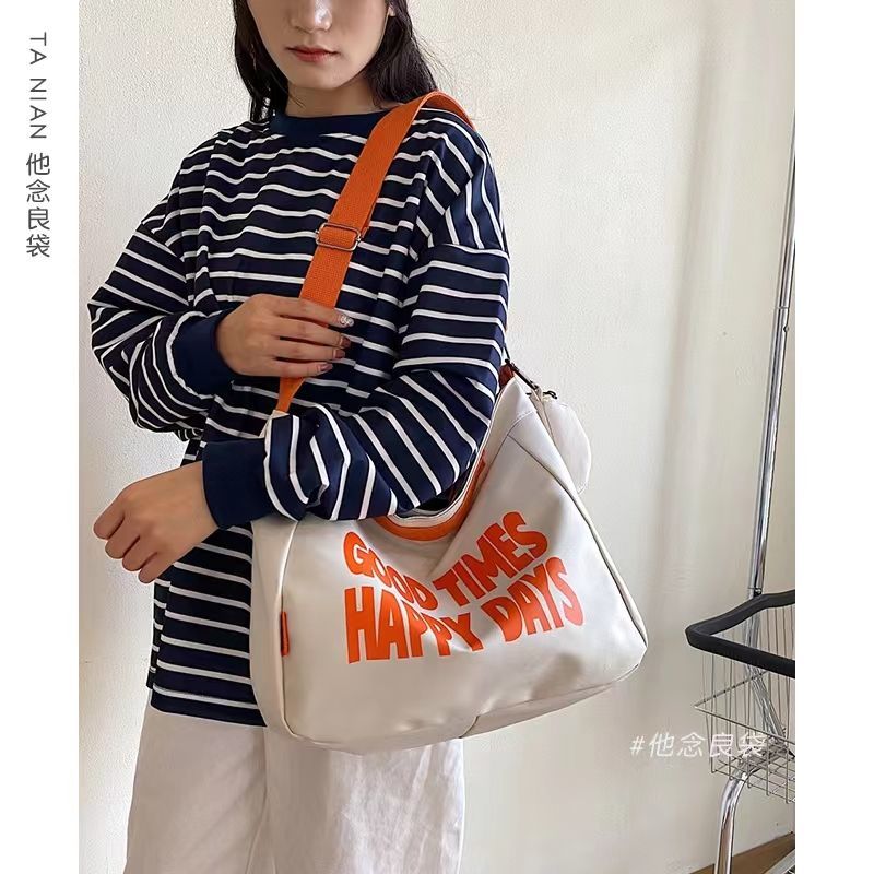 大容量慵懶風帆布包包女生2023新款ins字母單肩包簡約斜挎托特包