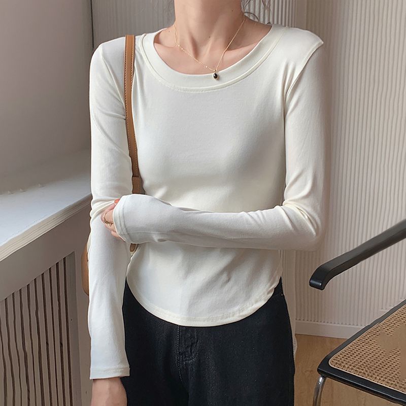 Simple white round neck long-sleeved bottoming shirt women's spring and autumn new design sense curved hem slim short top