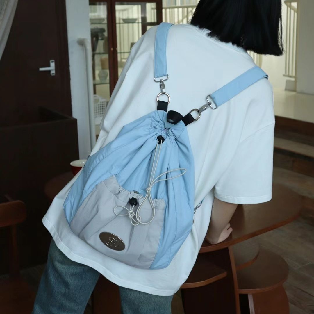 小眾設計抽繩雙肩包包女新款學生外出背包大容量斜挎單肩三用書包