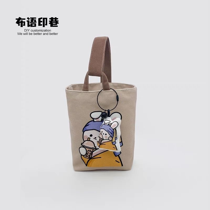 The first cup of milk tea in 2023 cartoon portable walking bucket bag large capacity travel mobile phone storage bag