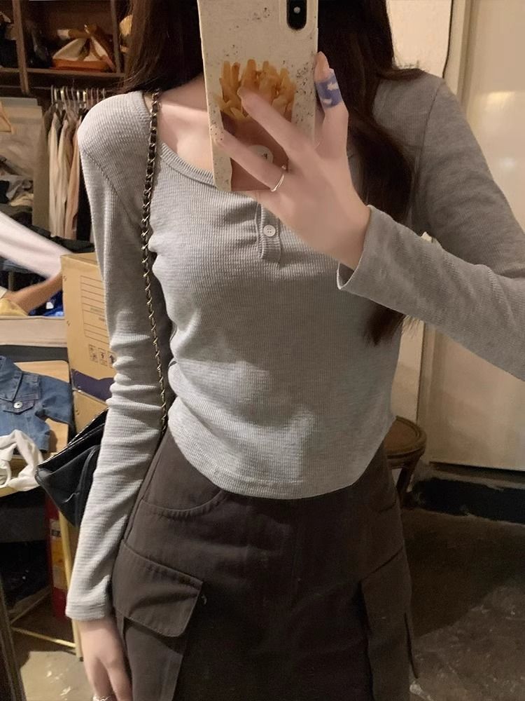 純欲辣妹半開領紐扣設計收腰打底衫T恤女秋季弧形下擺長袖短上衣