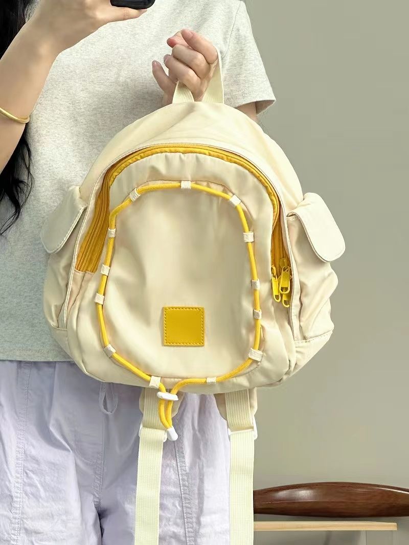 小眾童趣鵝蛋黃高級感校園學生上課書包新款輕便百搭耐用雙肩包女