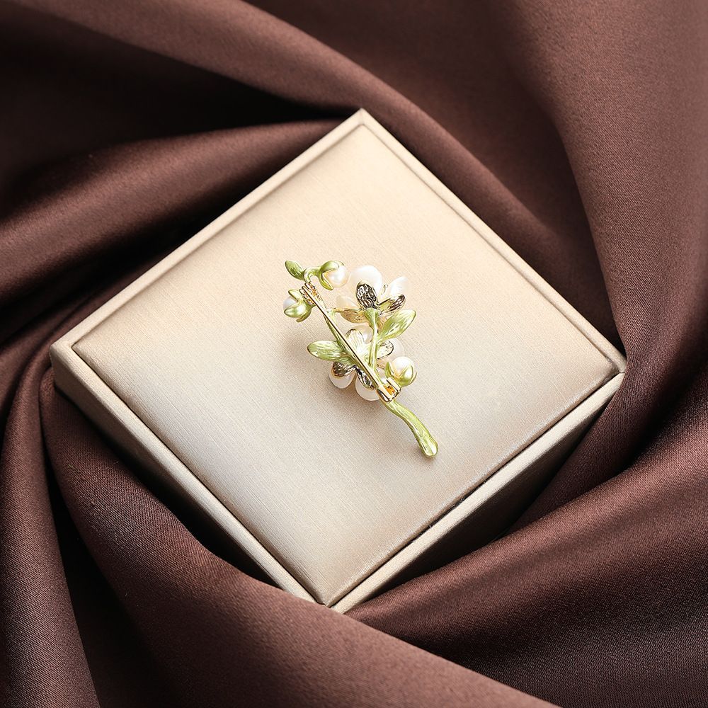 Elegant jasmin blomma brosch i grön konstnärlig design_voghion.com