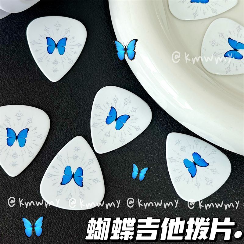 Nova palheta de guitarra de alta qualidade com estampa de borboleta azul em fundo branco, acessório essencial para baixo, guitarra elétrica e outros instrumentos._voghion.com